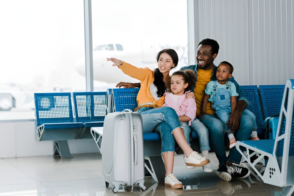 parents and two kids waiting for their flight in an airport
