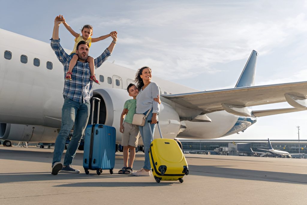 parents and two kids, with a plane in the background