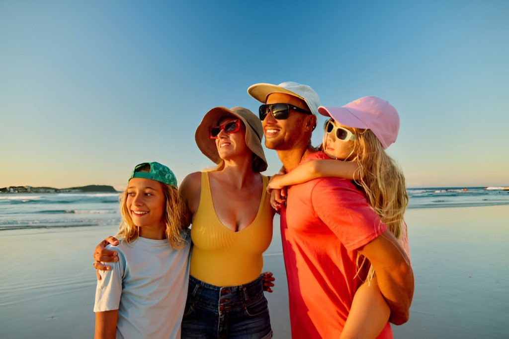family of four taking a beach trip